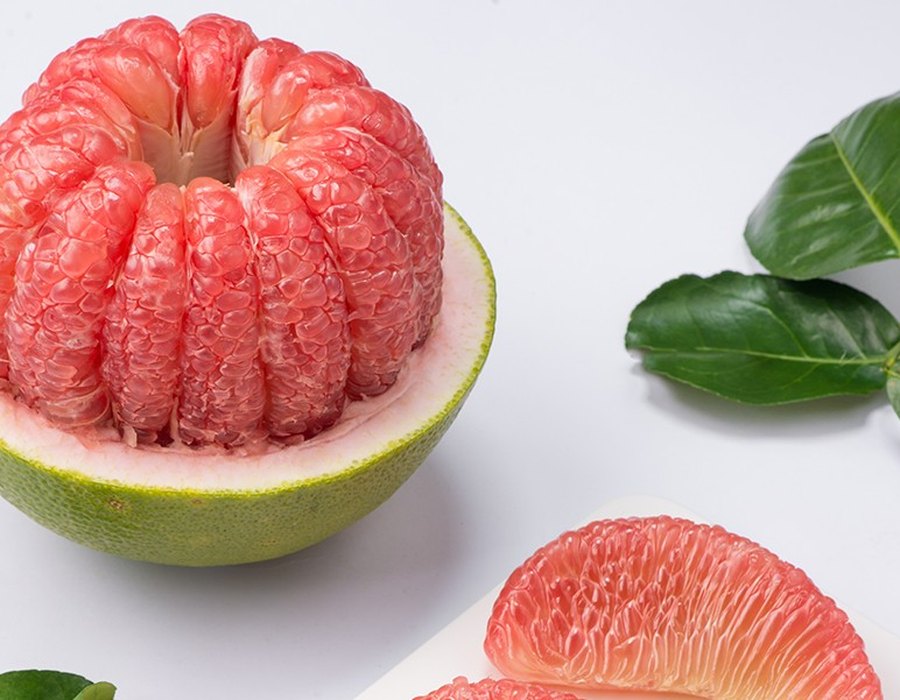 Green-skin pomelo, whole and cut